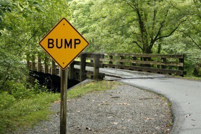 3305164-a-sign-warning-of-a-bump-ahead-in-the-road.jpg